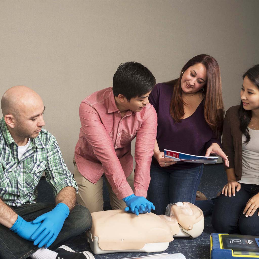 First aid course with a man practicing on a dummy
