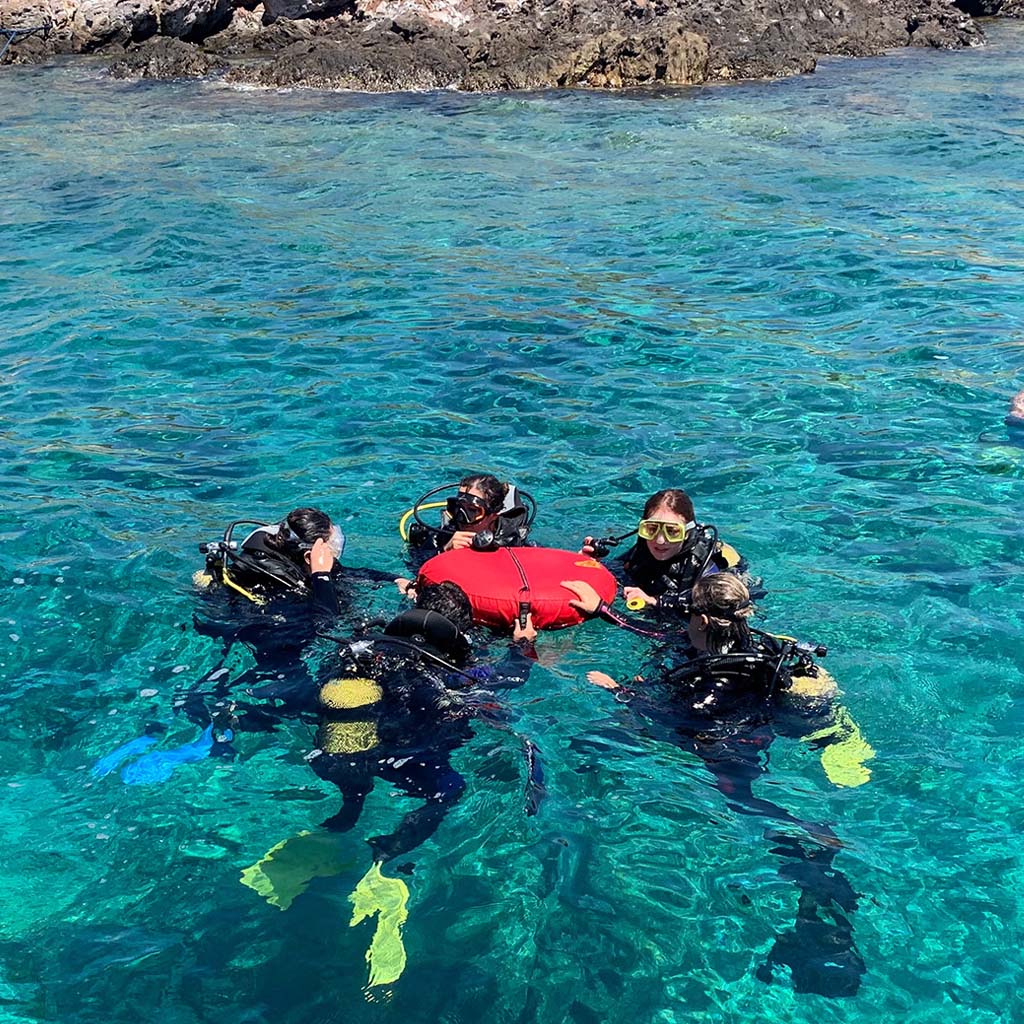 student divers in the ocean practicing exercises for the rescue diver course